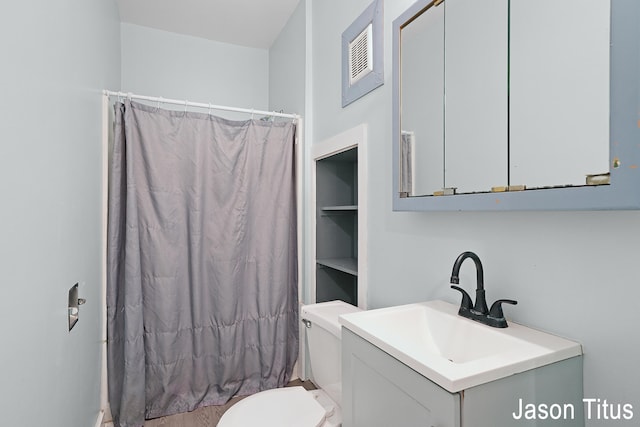 bathroom featuring a shower with shower curtain, vanity, and toilet