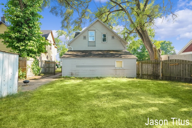 back of property featuring a lawn