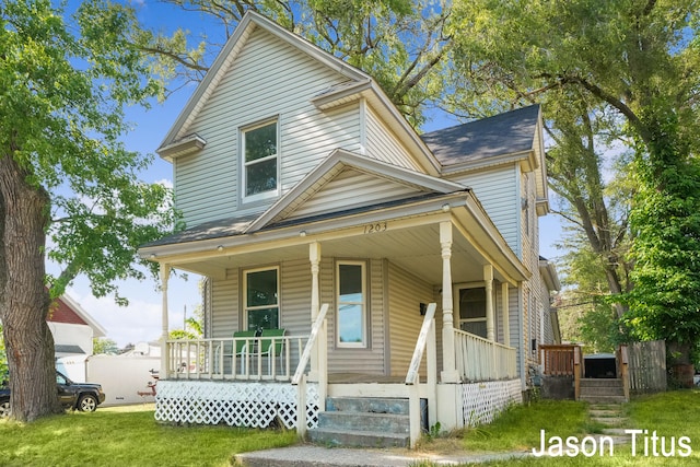 view of front of property with a porch and a front yard