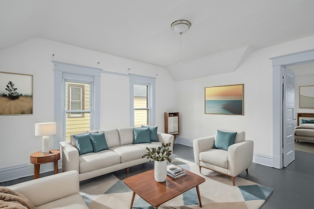 living room featuring concrete flooring and vaulted ceiling