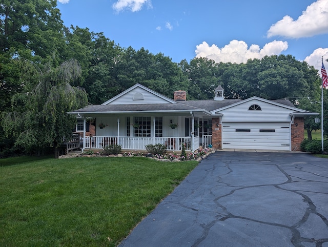 3641 Green Lake Rd, West Bloomfield, MI 48324 - single story home featuring brick siding, a porch, driveway, a front lawn, and an attached garage
