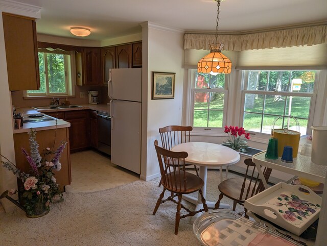 3641 Green Lake Rd, West Bloomfield, MI 48324 - kitchen with freestanding refrigerator, black dishwasher, light countertops, pendant lighting, and a sink