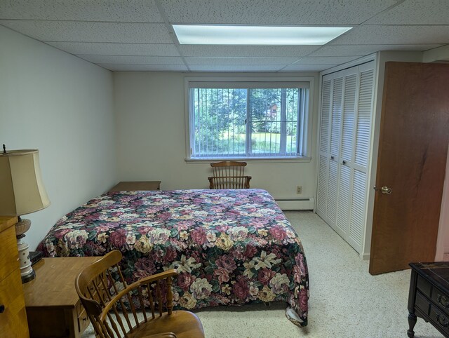 3641 Green Lake Rd, West Bloomfield, MI 48324 - carpeted bedroom featuring a baseboard heating unit, a drop ceiling, and a closet