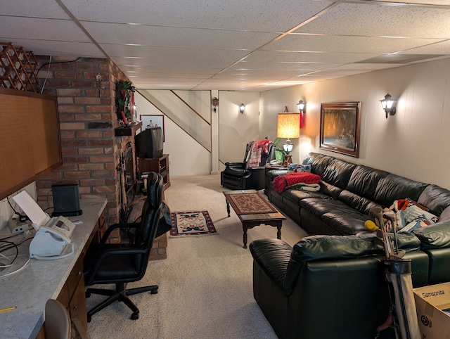 carpeted living room featuring a drop ceiling