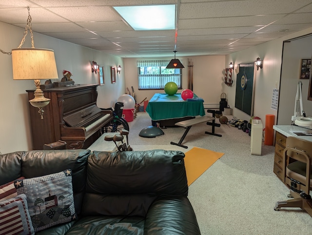 carpeted living room featuring a drop ceiling