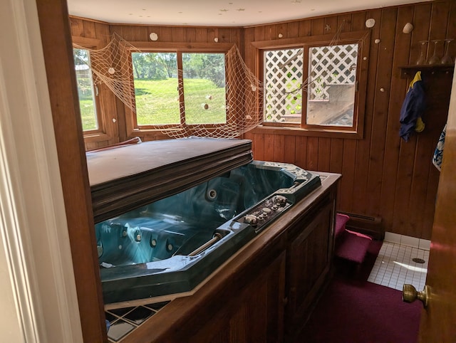 misc room featuring wood walls and a hot tub