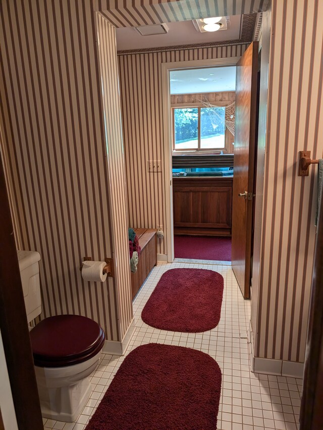3641 Green Lake Rd, West Bloomfield, MI 48324 - bathroom featuring toilet, wallpapered walls, tile patterned floors, and baseboards