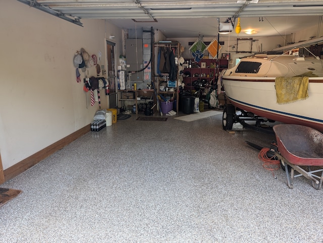 garage featuring heating unit and a garage door opener