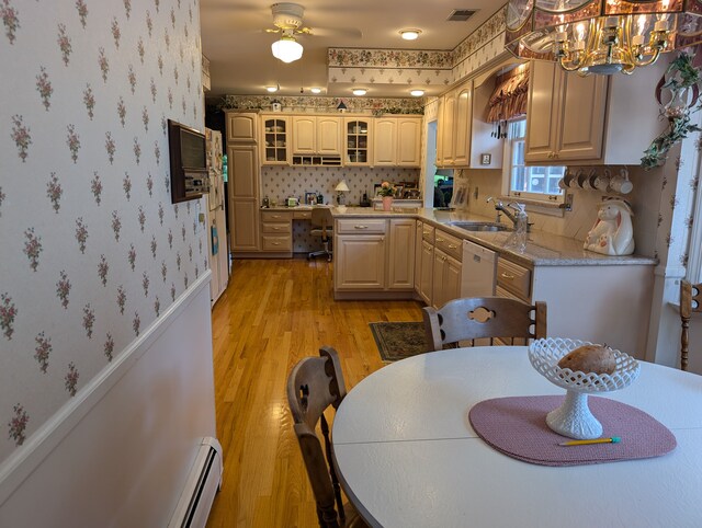 3641 Green Lake Rd, West Bloomfield, MI 48324 - kitchen featuring a sink, wallpapered walls, light wood-style flooring, dishwasher, and glass insert cabinets