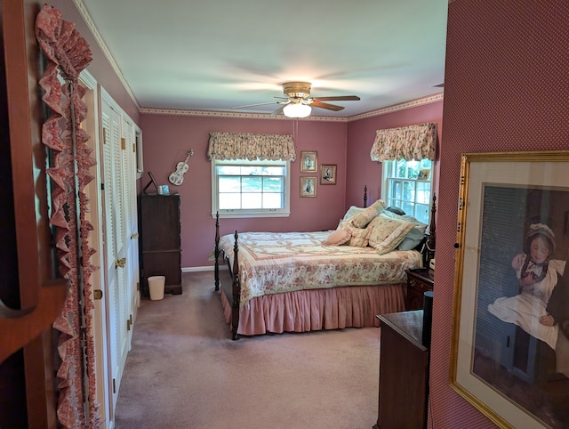 carpeted bedroom featuring ceiling fan and ornamental molding