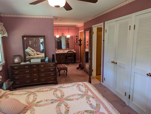 bedroom with ceiling fan and light colored carpet