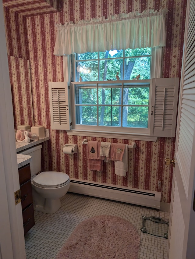 bathroom with tile patterned flooring, vanity, toilet, and a baseboard heating unit