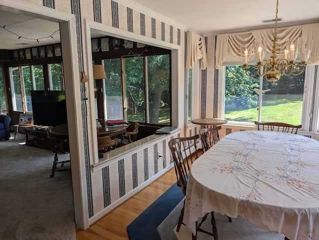 dining space with a chandelier and wood-type flooring