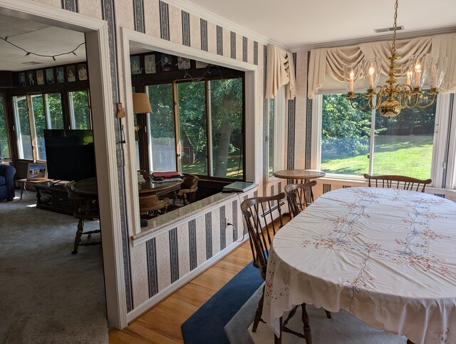3641 Green Lake Rd, West Bloomfield, MI 48324 - dining room with wallpapered walls, a chandelier, crown molding, and wood finished floors