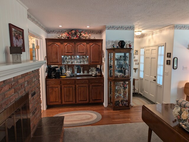 3641 Green Lake Rd, West Bloomfield, MI 48324 - bar featuring a textured ceiling, wood finished floors, a fireplace, and recessed lighting