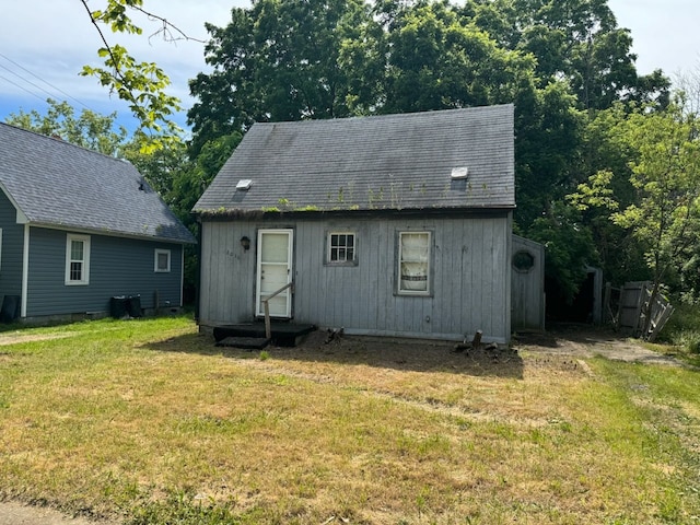 rear view of property with a lawn