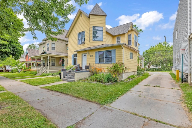 view of front of house with a porch and a front yard