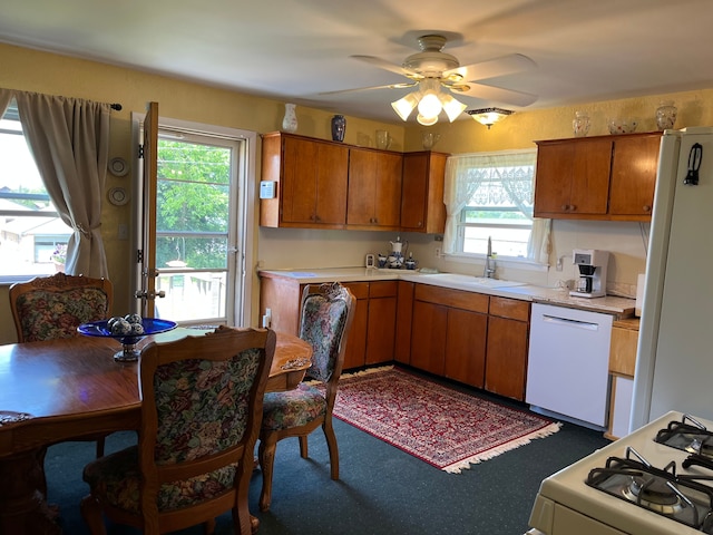 11424 W Corunna Rd, Lennon, MI 48449 - kitchen with a sink, white appliances, and brown cabinets