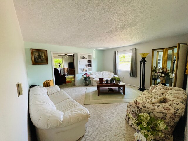 11424 W Corunna Rd, Lennon, MI 48449 - living room featuring light carpet, a textured ceiling, and a ceiling fan