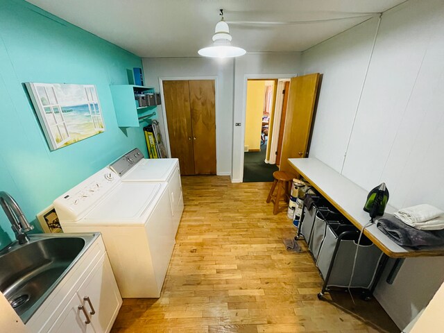 11424 W Corunna Rd, Lennon, MI 48449 - laundry area featuring washing machine and dryer, cabinet space, and light wood-style floors
