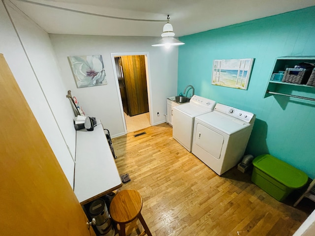 11424 W Corunna Rd, Lennon, MI 48449 - laundry room featuring cabinet space, washing machine and clothes dryer, and light wood-style floors