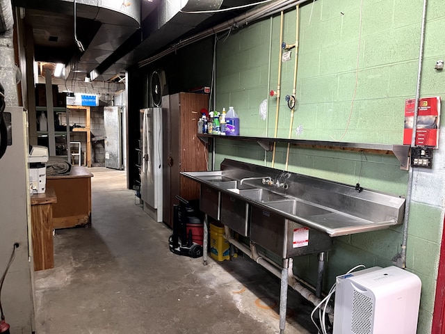 11424 W Corunna Rd, Lennon, MI 48449 - unfinished below grade area with concrete block wall and freestanding refrigerator