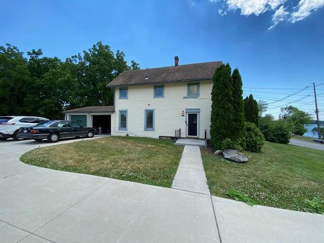 view of front of home with a front yard and a garage