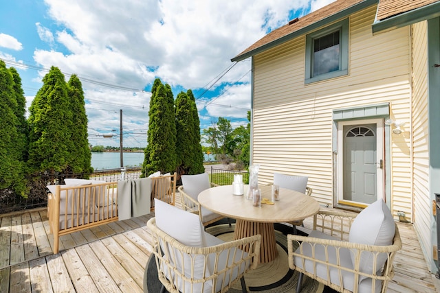 wooden deck featuring a water view