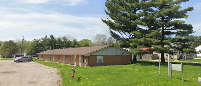 7351 N Dort Hwy, Mount Morris, MI 48458 - view of home's exterior with brick siding and a yard