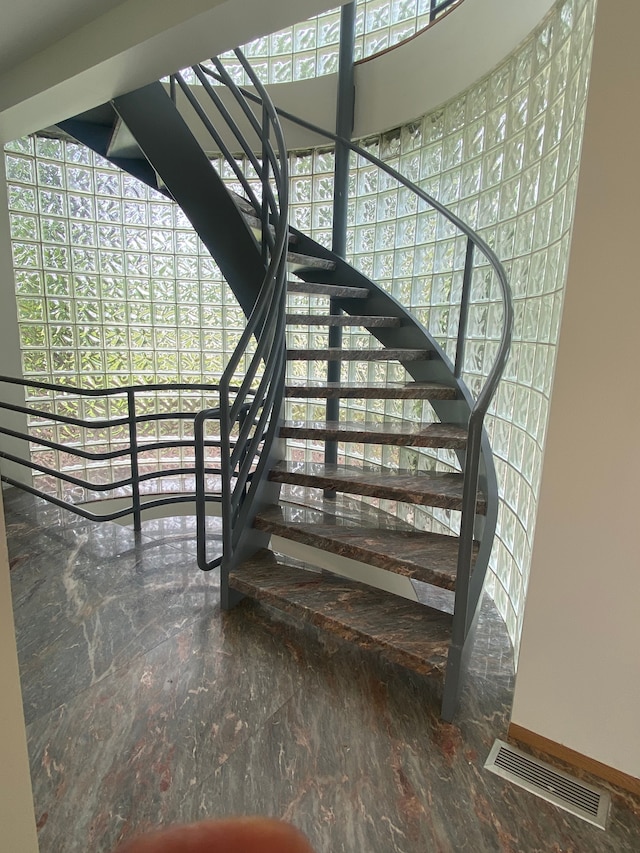 stairway featuring a wealth of natural light