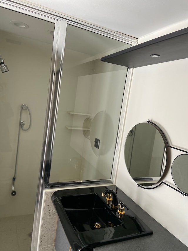 bathroom featuring sink and an enclosed shower