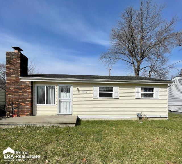 rear view of house with a yard and a patio