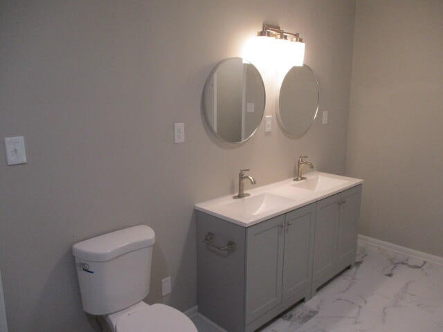 bathroom featuring vanity and toilet