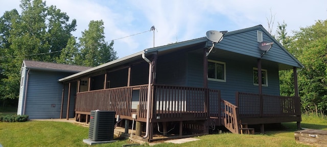 back of house featuring a yard, central air condition unit, and a wooden deck