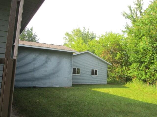 view of property exterior with a yard