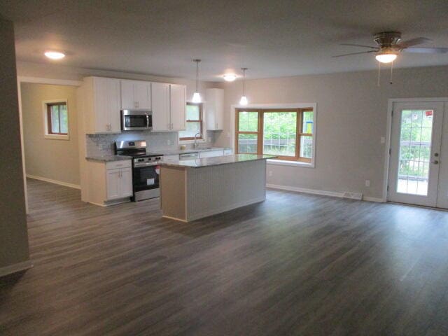 kitchen with a healthy amount of sunlight, white cabinetry, and stainless steel appliances