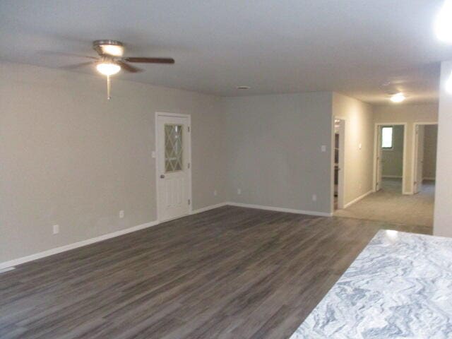 empty room featuring dark hardwood / wood-style floors and ceiling fan