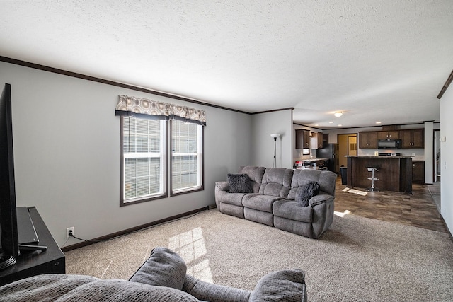 living room featuring dark colored carpet, a textured ceiling, and ornamental molding