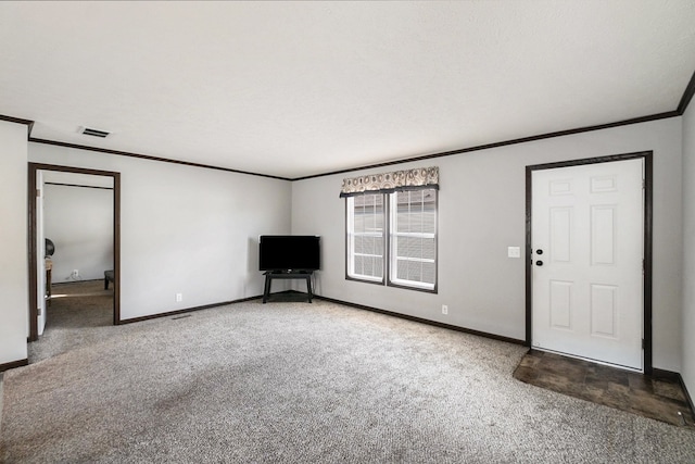 interior space with a textured ceiling, carpet floors, and crown molding