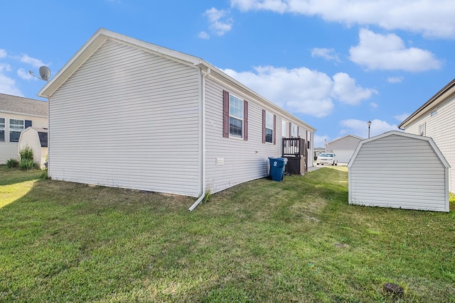 view of side of home with a yard