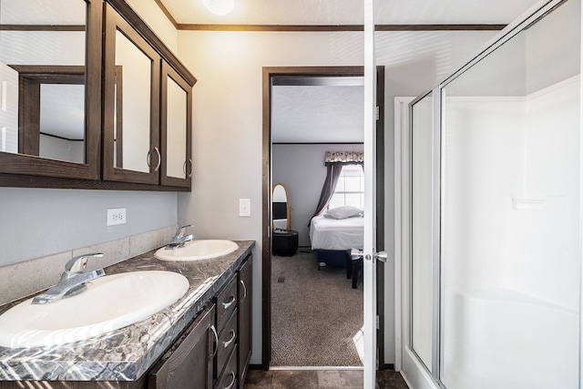 bathroom with vanity, a textured ceiling, and an enclosed shower