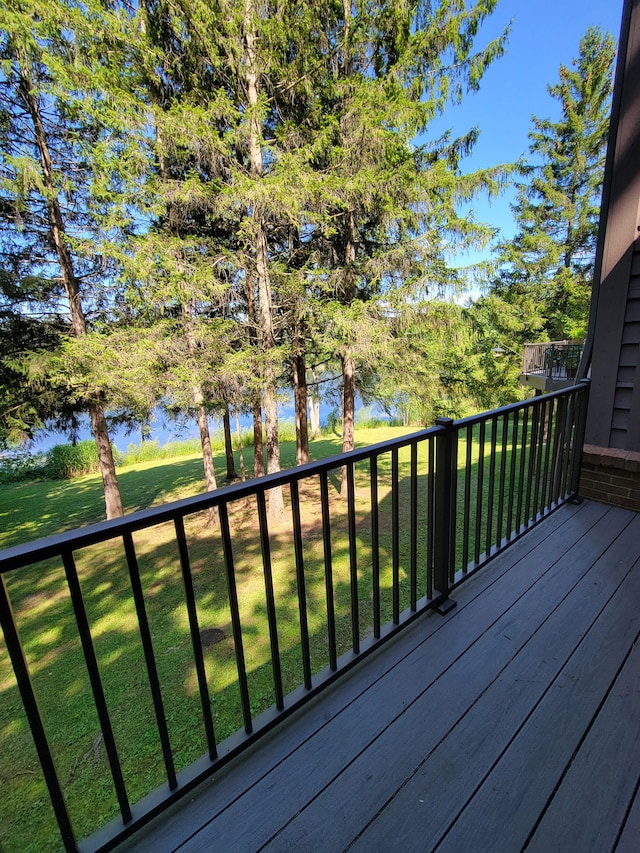 deck with a yard and a water view