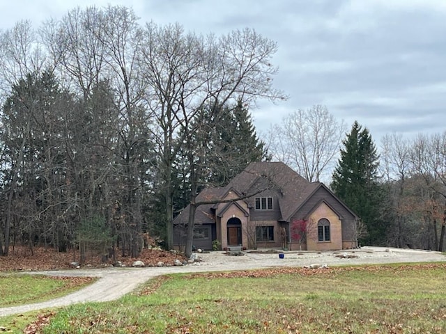 french provincial home with a front lawn