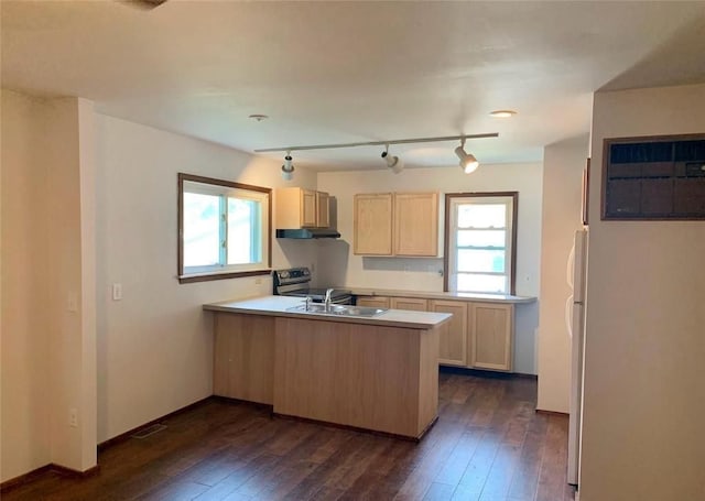 kitchen with kitchen peninsula, light brown cabinets, track lighting, and dark hardwood / wood-style floors