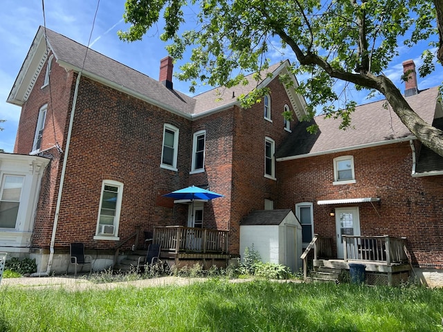 rear view of house with a storage shed