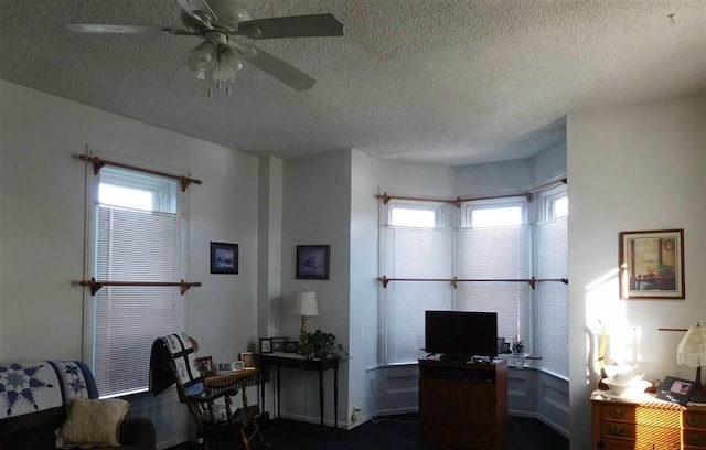 home office with a textured ceiling and ceiling fan