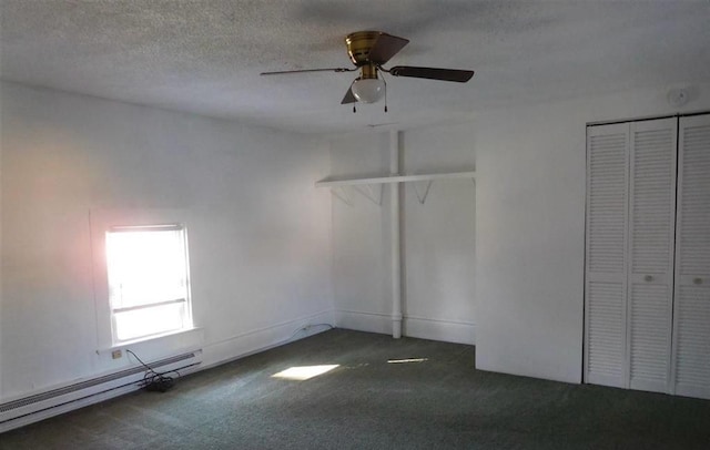 unfurnished bedroom with dark carpet, a baseboard heating unit, ceiling fan, a textured ceiling, and a closet