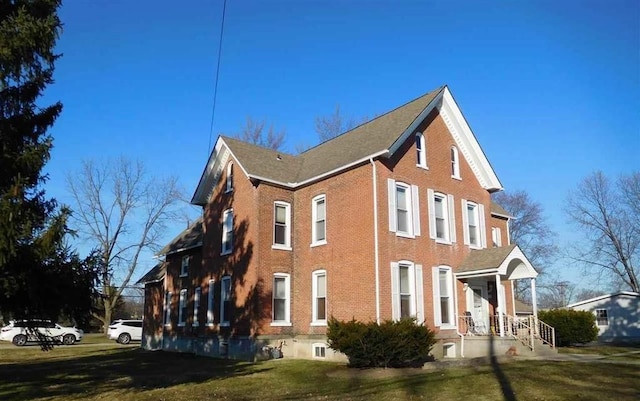 view of side of property with a yard