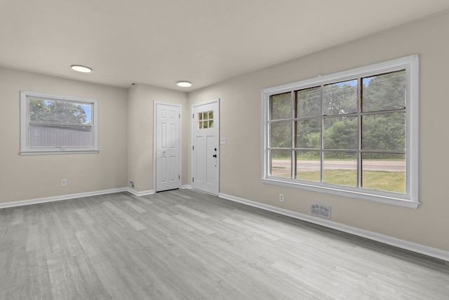 entrance foyer featuring plenty of natural light and light hardwood / wood-style floors