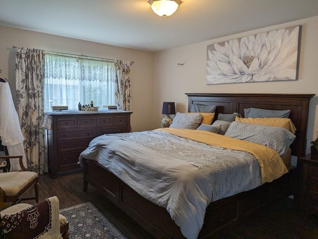 bedroom with dark hardwood / wood-style floors